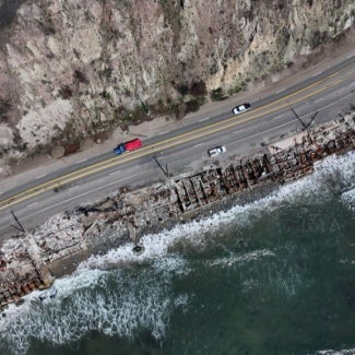 aerial view of pacific coast highway with fire damage on ocean side